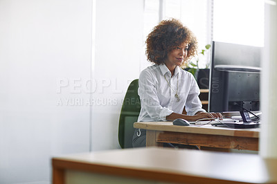 Buy stock photo Cropped shot of a beautiful young businesswoman sitting in her office