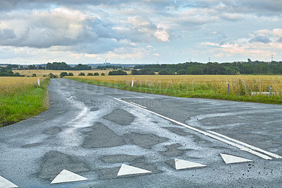 Buy stock photo A country road meandering through a picturesque landscape