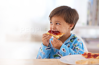 Buy stock photo A cute little boy eating breakfast