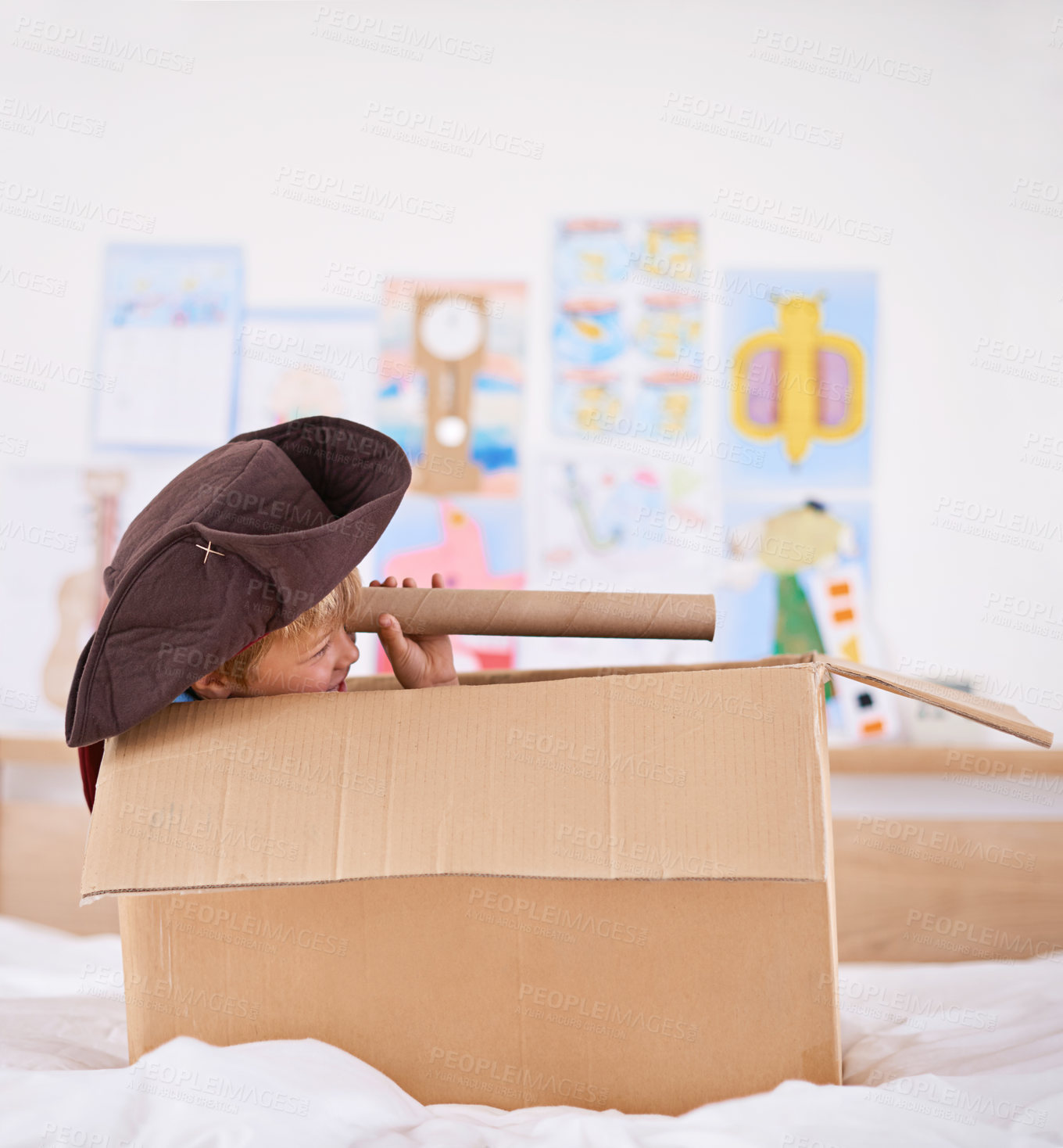 Buy stock photo Boy, box and pirate hat with spyglasses on bed for playing, adventure and game as creativity. Kid, cardboard and home with telescope in bedroom for fun, journey and activity as imagination