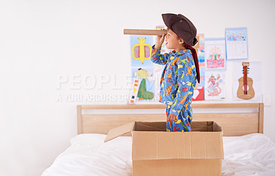 Buy stock photo Child, box and pirate hat with spyglasses on bed in home for play, adventure and game as creativity. Boy, cardboard and tricorn with telescope in bedroom for fun, journey and activity as imagination