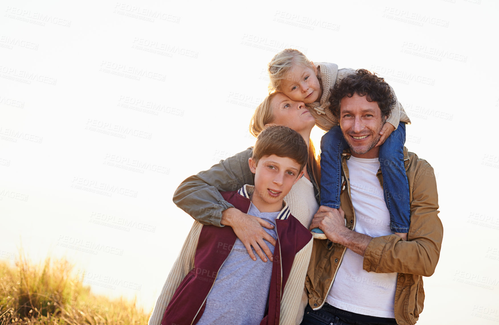Buy stock photo Happy family, portrait and smile with field, walk and sunrise for morning exercise and bond. Parents, children and countryside for health, wellness and outdoor adventure at sunset for holiday