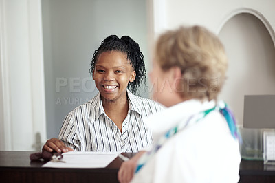 Buy stock photo Hotel receptionist, concierge and a black woman helping a senior tourist to check in at a luxury resort. Hospitality, travel or holiday getaway with a happy female secretary in a lodge for assistance