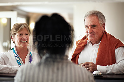Buy stock photo Cropped shot of a senior couple checking in at the hotel