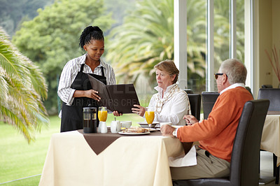 Buy stock photo Waitress, menu and senior couple in restaurant on romantic date together on hotel terrace. Old man, woman and server with breakfast, food card and relax in luxury hospitality, fine dining and choice.