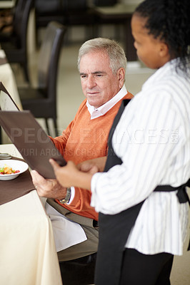 Buy stock photo Waitress, hotel and senior man in a restaurant for breakfast or lunch at a hotel with a menu and choice of food. Friendly, order and elderly person happy on vacation or holiday for hospitality