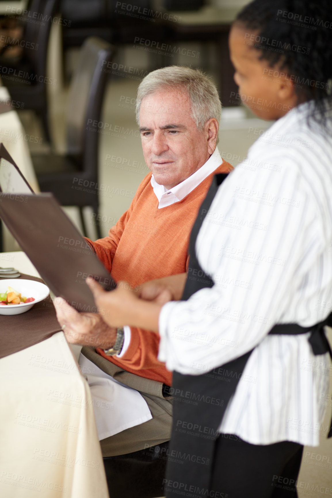Buy stock photo Waitress, hotel and senior man in a restaurant for breakfast or lunch at a hotel with a menu and choice of food. Friendly, order and elderly person happy on vacation or holiday for hospitality