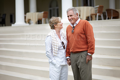 Buy stock photo Happy senior couple, stairs and vacation at hotel, resort or holiday house for retirement together. Mature man and woman smile for break, relax or outdoor romance holding hands on staircase at home
