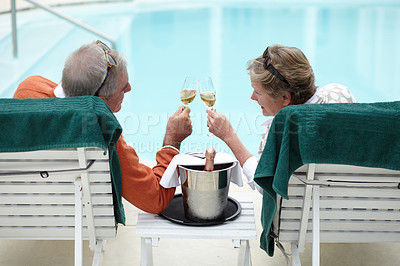 Buy stock photo Rearview shot of a senior couple toasting while on vacation