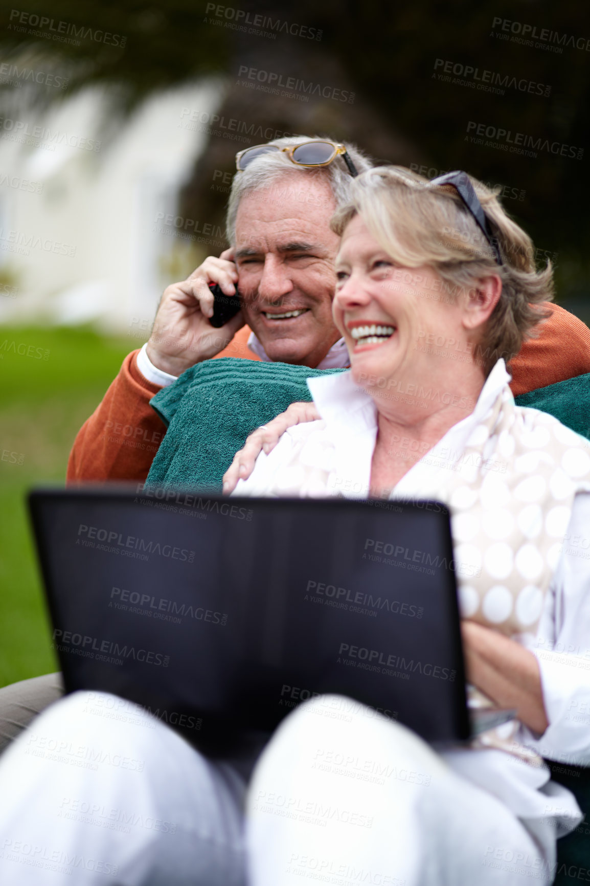 Buy stock photo Phone call, laptop and an old couple in the garden of a hotel for travel or vacation at a luxury resort. Love, technology or communication with a senior man and woman tourist outdoor at a lodge