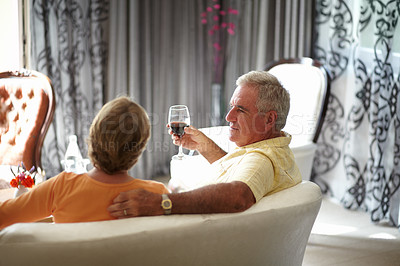 Buy stock photo Retirement, sofa and an old couple drinking wine in their hotel room while on holiday or vacation together. Toast, love or relax with a senior man and woman bonding at a luxury resort for romance