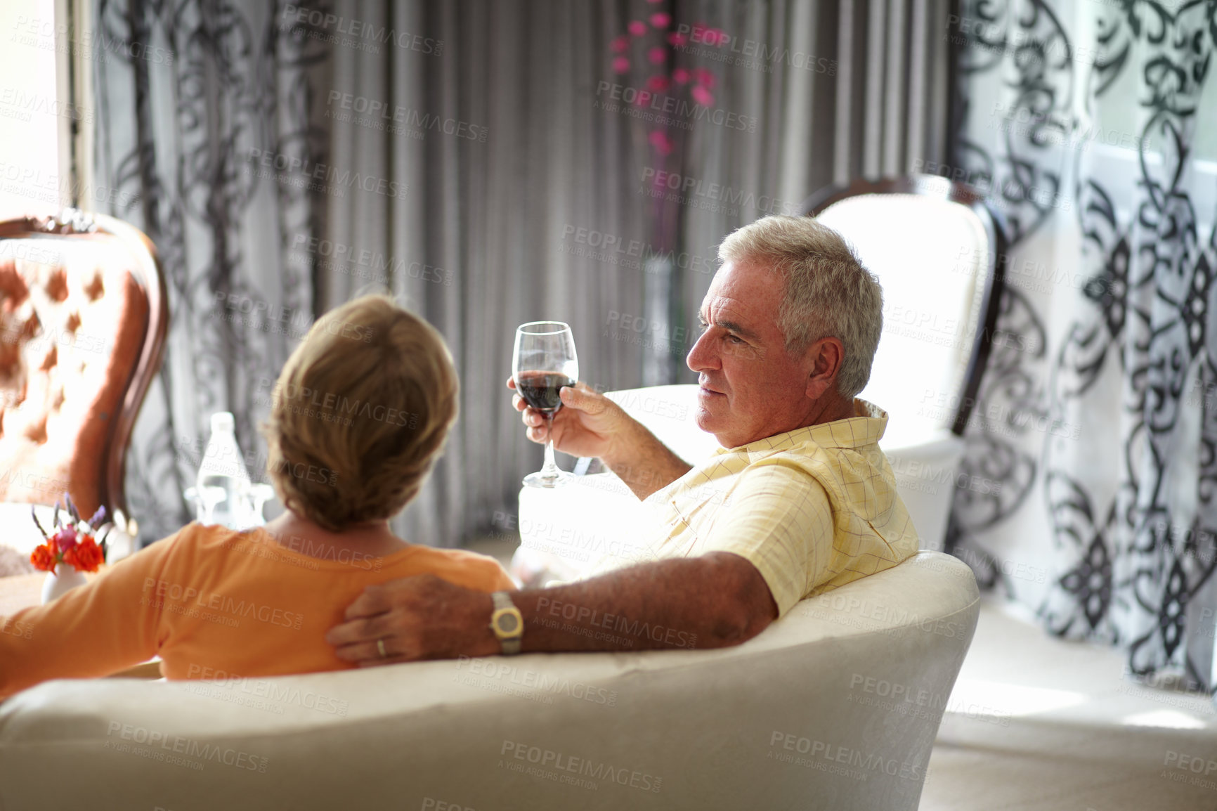 Buy stock photo Retirement, sofa and an old couple drinking wine in their hotel room while on holiday or vacation together. Toast, love or relax with a senior man and woman bonding at a luxury resort for romance