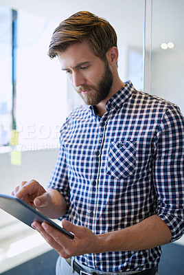 Buy stock photo Serious, business and man at office with tablet on internet for research, reviews or post as social media manager. Male person, employee and texting on website or online for email or communication