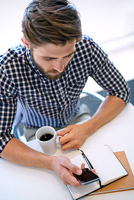 Buy stock photo Office, businessman and smartphone with notebook for email notification, social media and post on break. Above, male person and text message on app with coffee for communication and networking