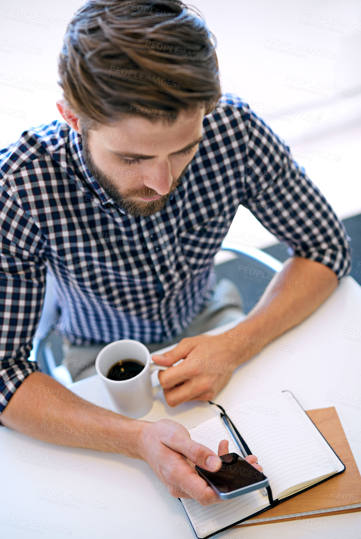 Buy stock photo Office, businessman and smartphone with notebook for email notification, social media and post on break. Above, male person and text message on app with coffee for communication and networking