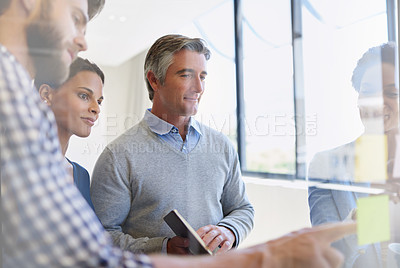 Buy stock photo Shot of a group of coworkers brainstorming during a meeting
