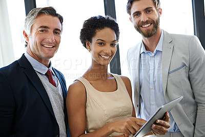 Buy stock photo Portrait of a group of coworkers discussing standing together with a digital tablet