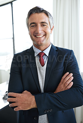 Buy stock photo Portrait of a mature businessman smiling while standing with his arms crossed