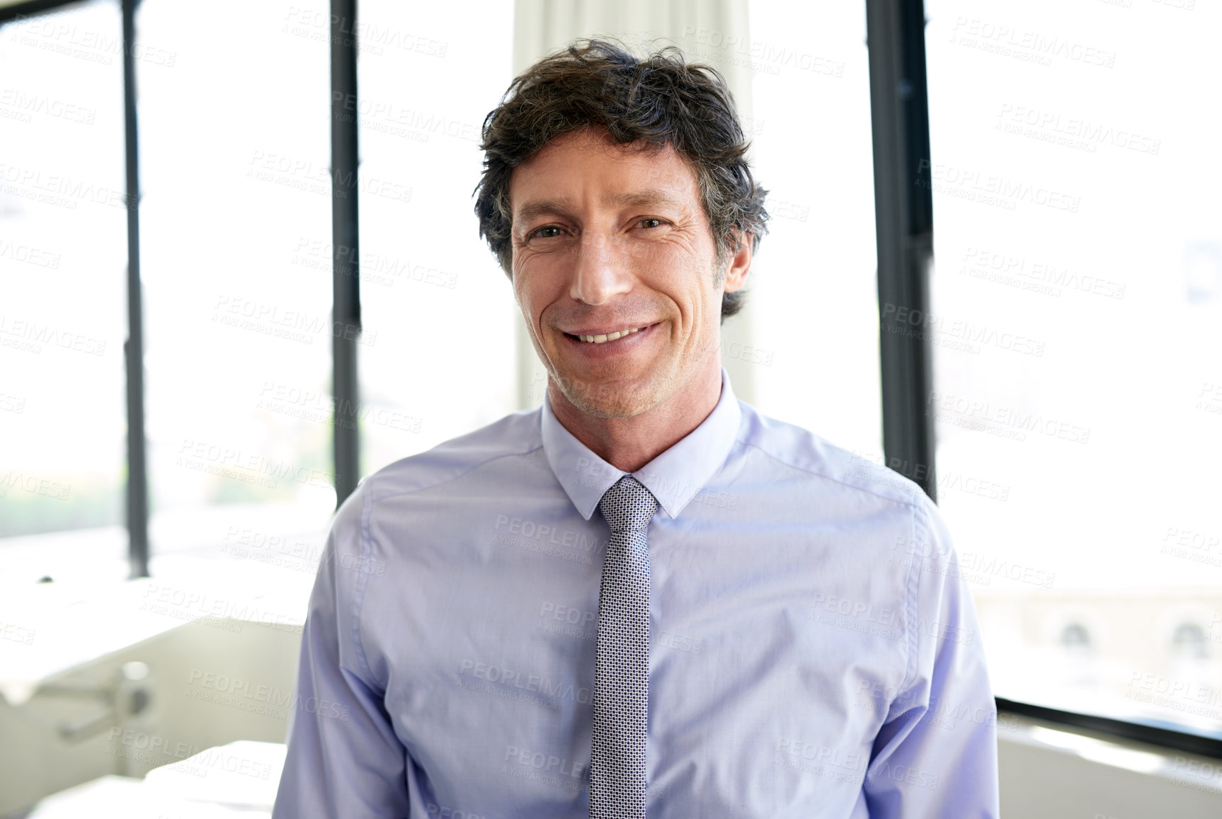 Buy stock photo Portrait of a businessman in an office with large windows