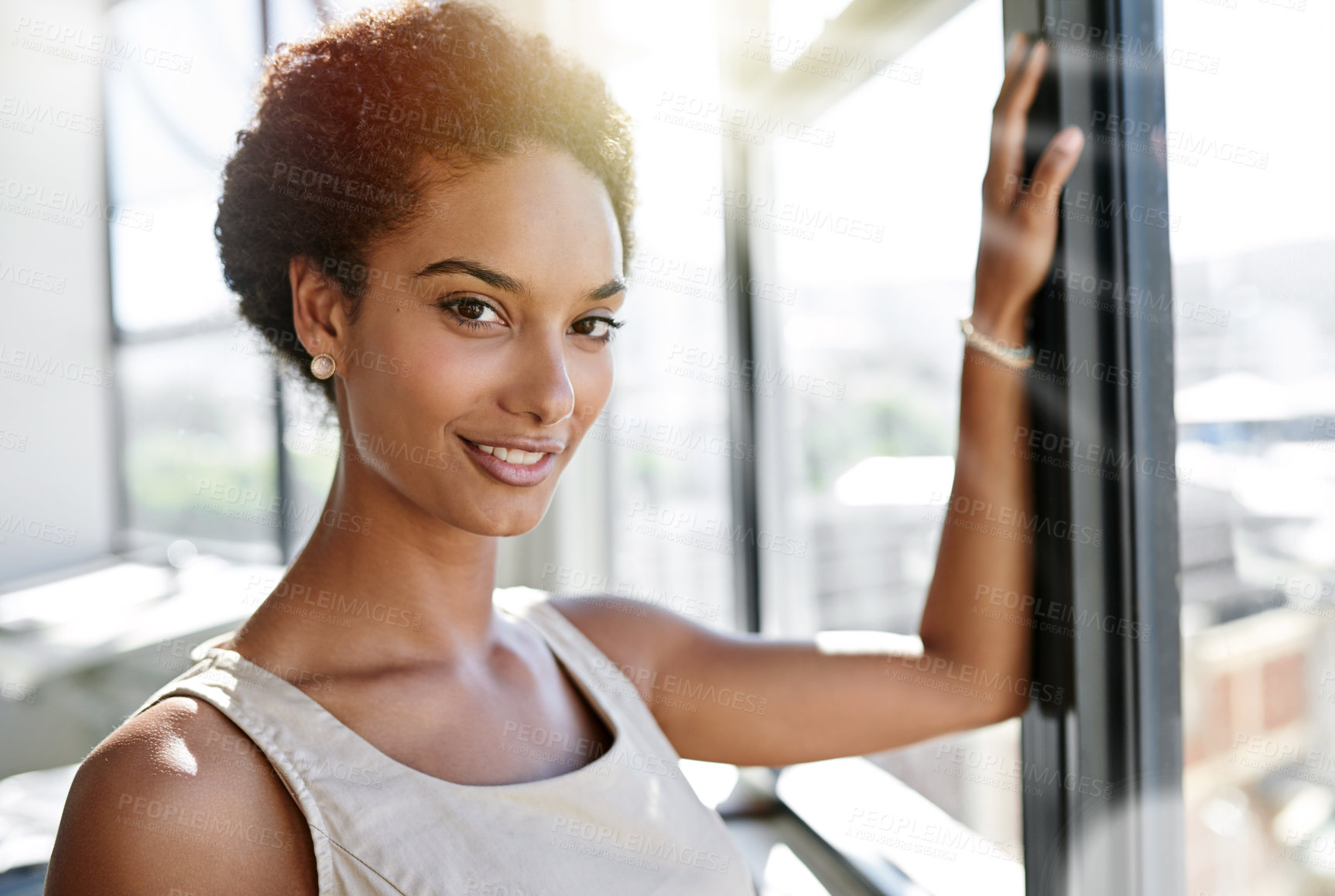 Buy stock photo Portrait of a confident young businesswoman in an office with large windows