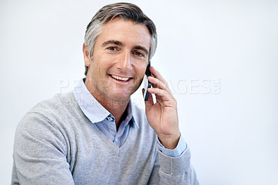 Buy stock photo Shot of a mature businessman talking on his cellphone