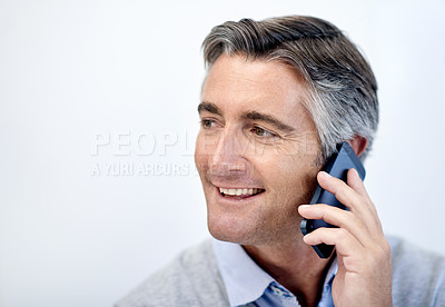 Buy stock photo Shot of a mature businessman talking on his cellphone
