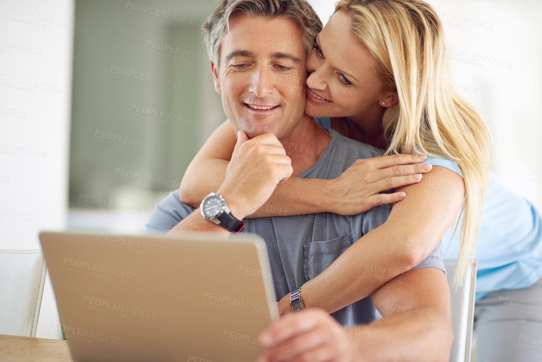 Buy stock photo Shot of a happy mature couple using a laptop at home