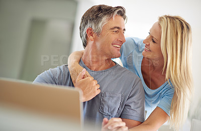 Buy stock photo Shot of a happy mature couple using a laptop at home
