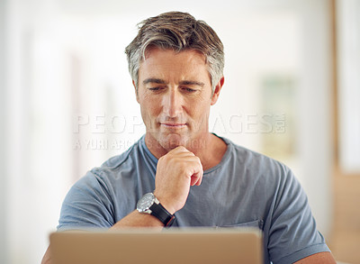 Buy stock photo Shot of a mature man using a laptop at home