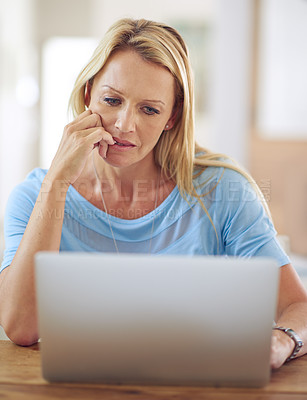 Buy stock photo Shot of a mature woman using a laptop at home