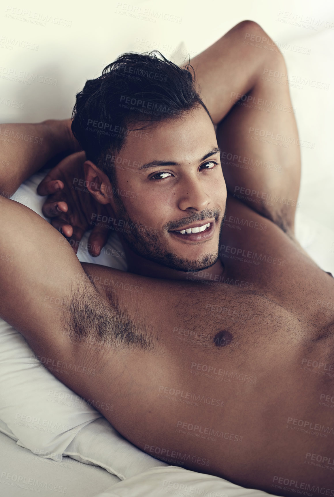 Buy stock photo Portrait, smile and morning with a sexy man in bed, shirtless after a rest to relax while ready to wake up. Face, happy and body with a handsome or sensual young male model lying topless in a bedroom