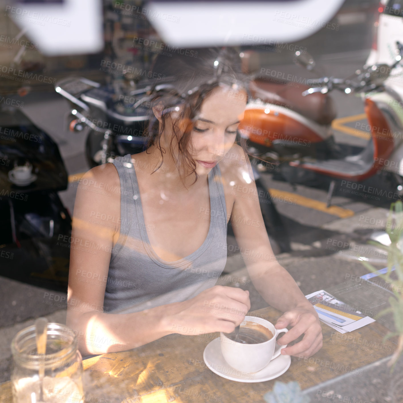 Buy stock photo Cropped shot of a young woman drinking coffee at a cafe