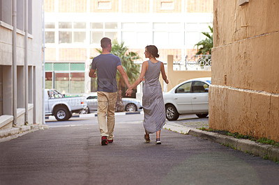 Buy stock photo Shot of a young couple taking a walk outdoors