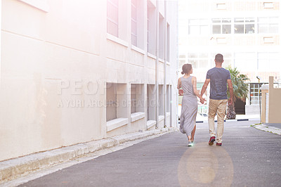 Buy stock photo Shot of a young couple taking a walk outdoors