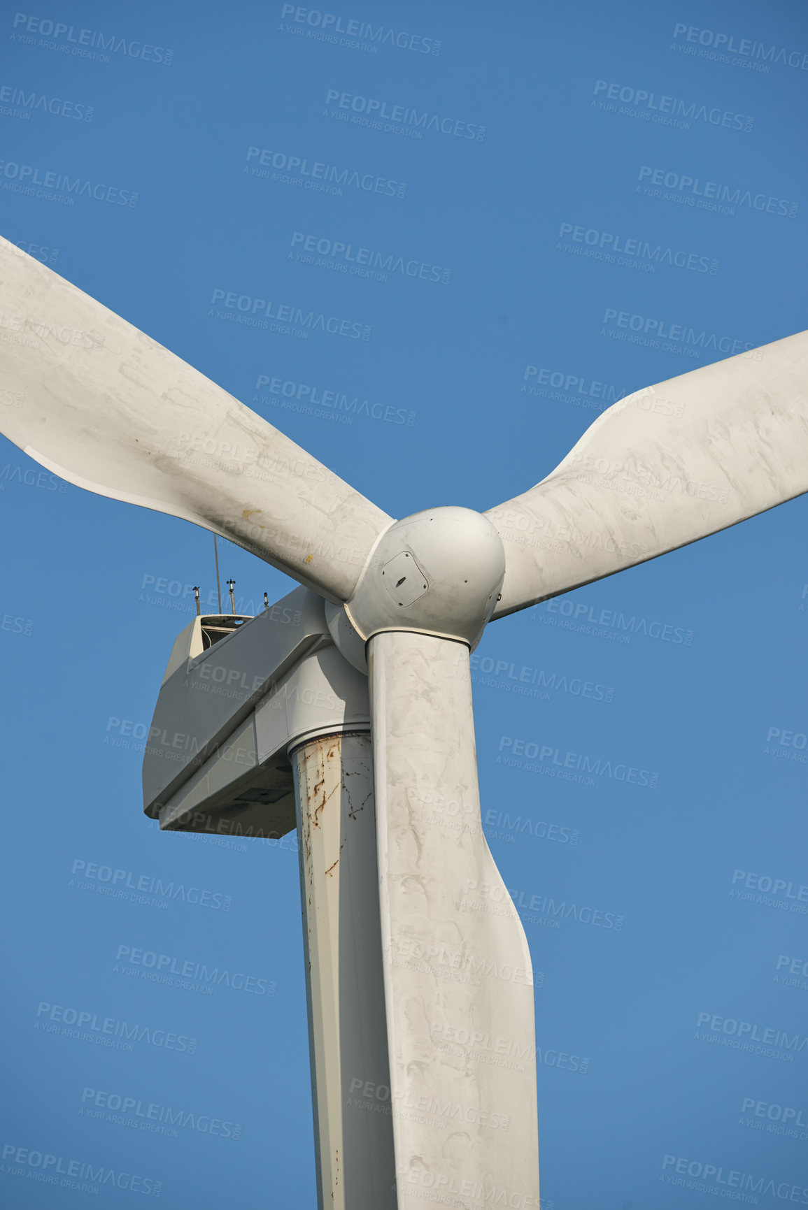 Buy stock photo Windmill, renewable energy and environment by blue sky for sustainability with natural power source. Wind turbine, blades and infrastructure to supplement supply grid for clean electricity in Denmark