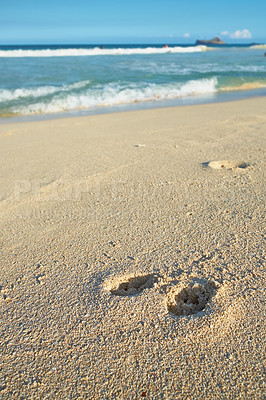 Buy stock photo Nature, ocean and footprints in sand for travel, vacation or holiday in summer by coastal island. Walk mark, steps and sea waves on LaniKai beach for tropical weekend trip at destination in Hawaii.