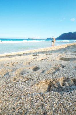 Buy stock photo Blue sky, sea and footprints in sand for travel, vacation or holiday in summer by coastal island. Walk mark, steps and ocean waves on LaniKai beach for tropical weekend trip at destination in Hawaii.