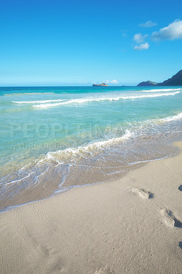 Buy stock photo Blue sky, ocean and footprints in sand for travel, vacation or holiday in summer by coastal island. Walk mark, steps and sea waves on LaniKai beach for tropical weekend trip at destination in Hawaii.