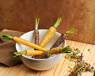 Buy stock photo Carrots, organic and cooked in bowl on board for cooking with vegetable on table top for nutrition. Healthy, vision and weight loss with snack for gourmet cuisine with eating for vitamin for vegan