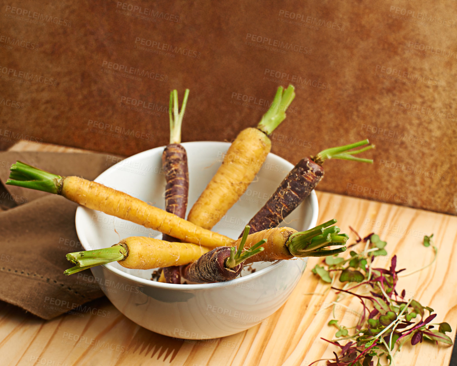 Buy stock photo Carrots, organic and cooked in bowl on board for cooking with vegetable on table top for nutrition. Healthy, vision and weight loss with snack for gourmet cuisine with eating for vitamin for vegan