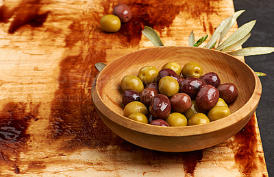 Buy stock photo Olives, fibre and fruit on wood board in Greece for holiday, health and wellness in restaurant. Weight loss, brine and leaves on table for antioxidant, nutrition and vegan for low calorie snack.