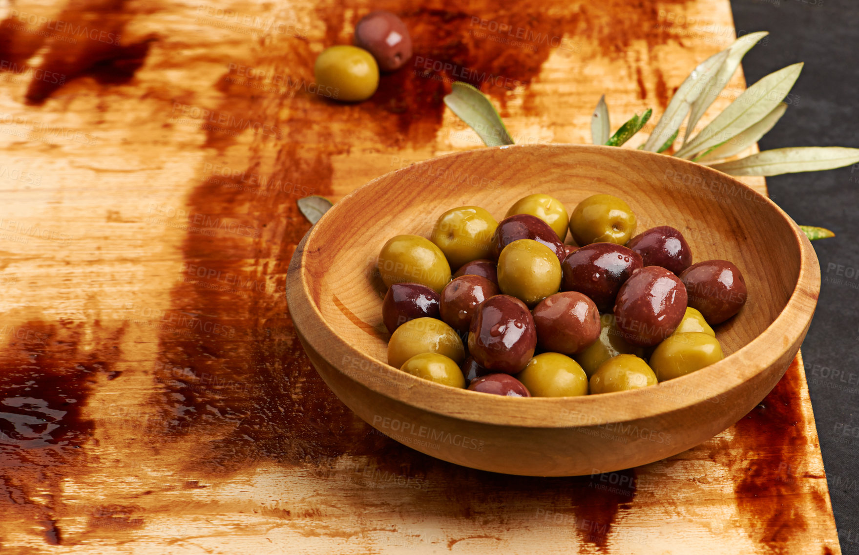 Buy stock photo Olives, fibre and fruit on wood board in Greece for holiday, health and wellness in restaurant. Weight loss, brine and leaves on table for antioxidant, nutrition and vegan for low calorie snack.