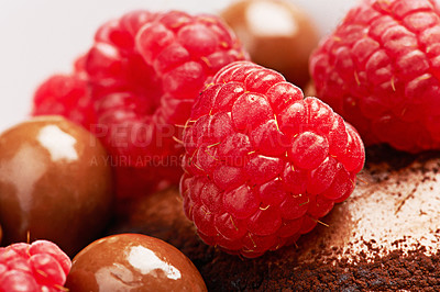 Buy stock photo Raspberry, chocolate and cake with dessert in closeup for eating with sugar in studio with sweets for treats with baking. Food, hungry and cupcake with fruit for gourmet, meal and candy for carbs