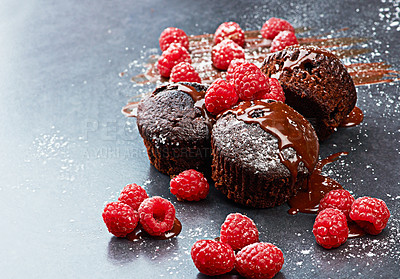 Buy stock photo Raspberry, muffin and fruit by dark background for chocolate, liquid and dessert with icing sugar. Berry, white powder and cupcake on countertop with red color for rich taste, bakery and sweet food