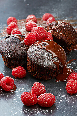 Buy stock photo Berry, cupcake and fruit by dark background for chocolate, liquid and dessert with icing sugar. Raspberry, muffin and white powder on countertop with red color for bakery, rich taste and sweet food