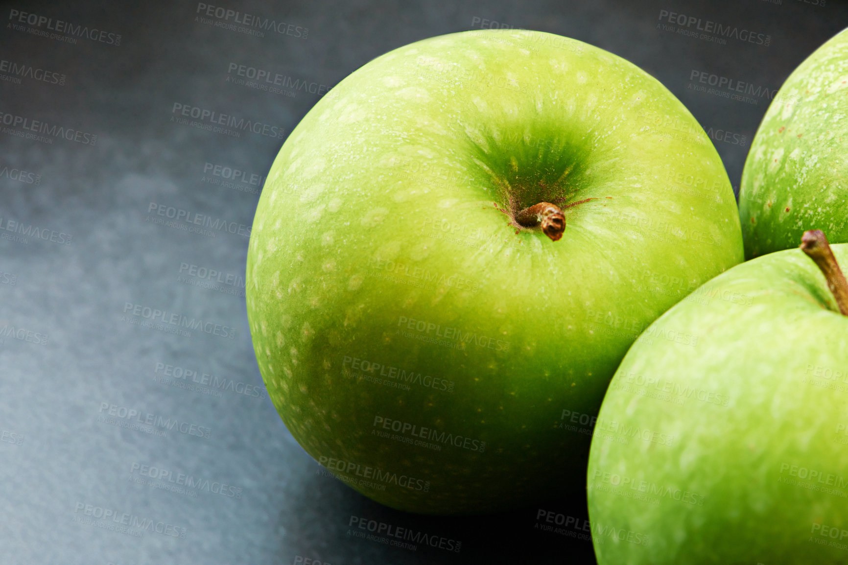 Buy stock photo Closeup, natural or apples for diet in kitchen of home on counter for food, vitamin c or healthy nutrition. Vegan, background and fruits with green color in house for meal, detox or snack minerals