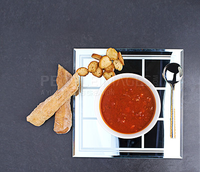 Buy stock photo Tomato, soup and bread on menu in restaurant with bowl of healthy food for diet and nutrition benefits. Dinner, dish and luxury appetizer course in fine dining kitchen with breadsticks on plate