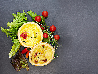 Buy stock photo Tart, vegetables and food on dark background for bakery with pastry, nutrition and brunch meal. Pie, carbs and tomato on countertop for breakfast cooking, green color and healthy eating with hungry