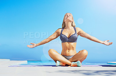 Buy stock photo Shot of a beautiful young woman exercising outside