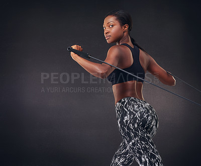 Buy stock photo Studio shot of a beautiful young woman working out against a black background